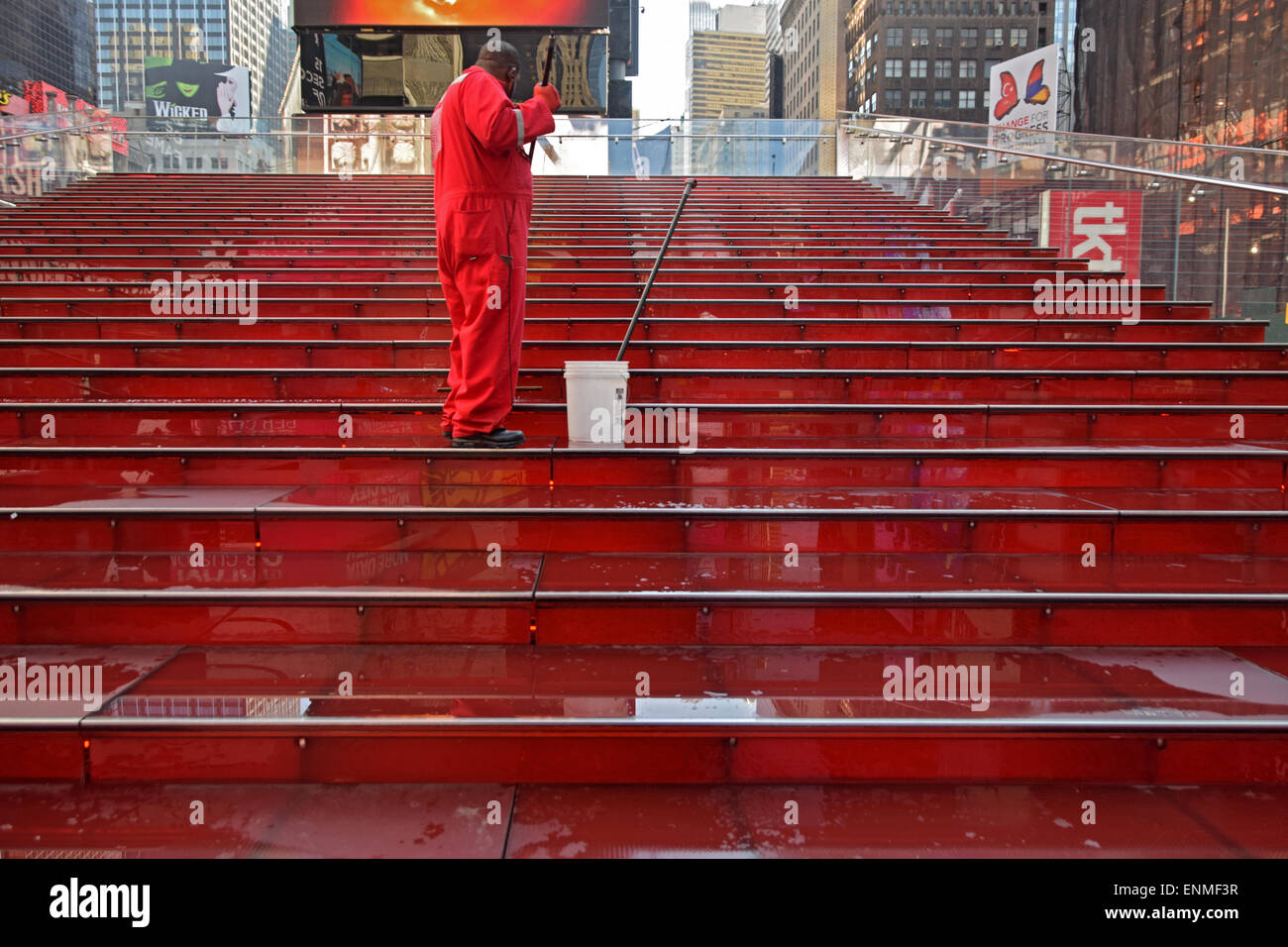 Worker cleaning the iconic red steps behind the TKTS discount theater tickets booth in Midtown Manhattan, NYC Stock Photo