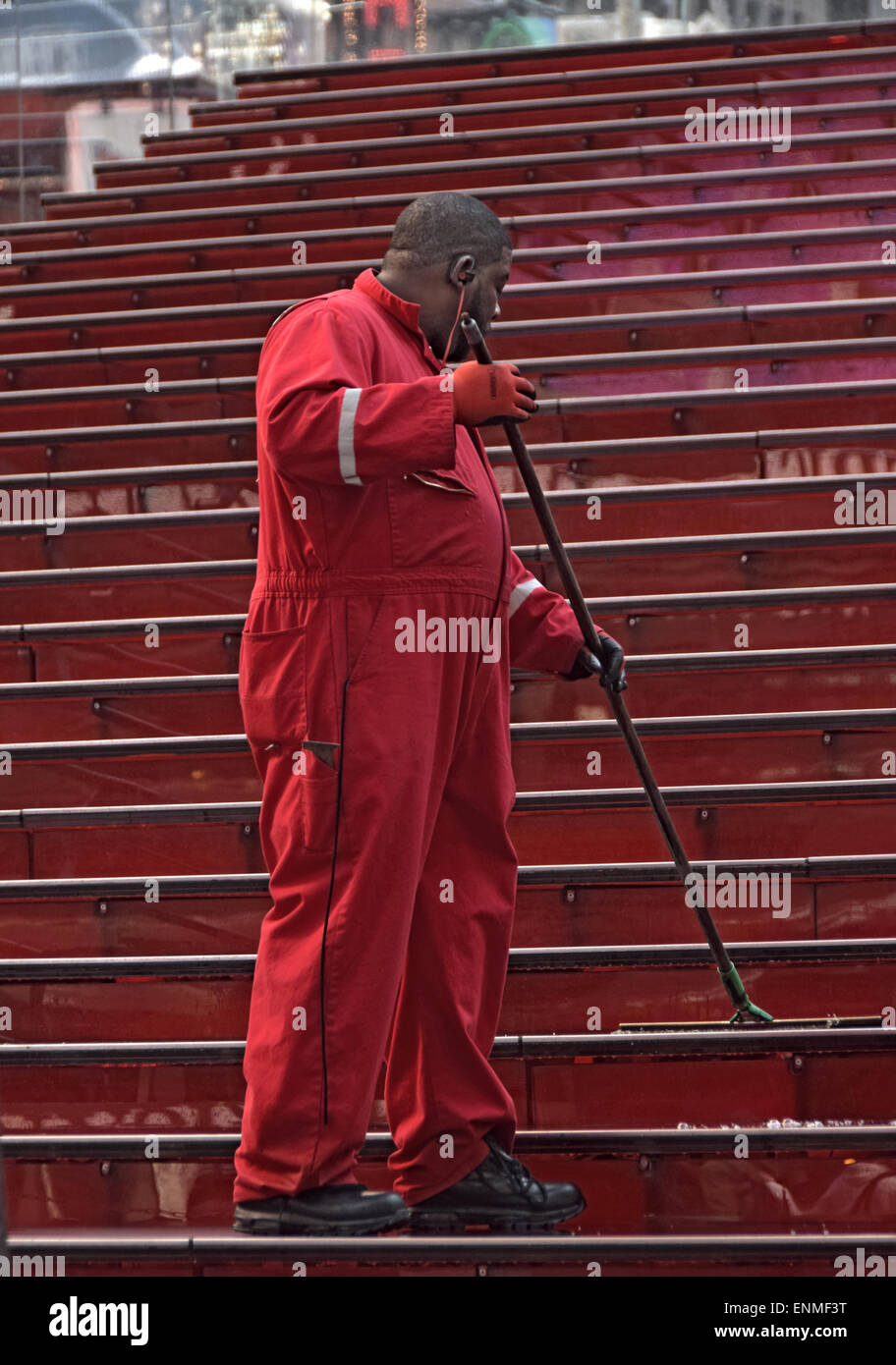 Worker cleaning the iconic red steps behind the TKTS discount theater