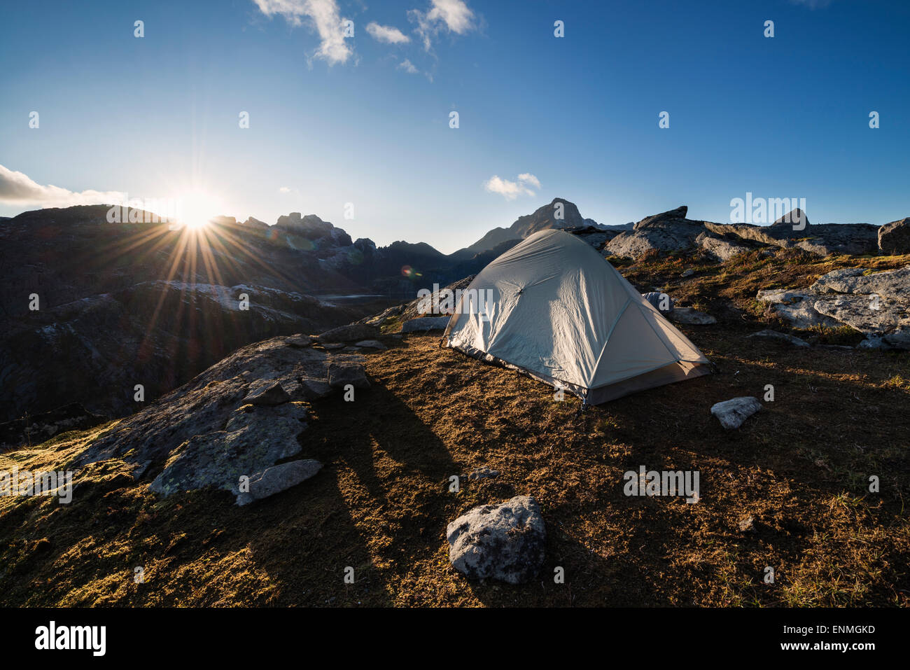 Tent and setting sun in mountain campsite, Moskenesøy, Lofoten Islands, Norway Stock Photo