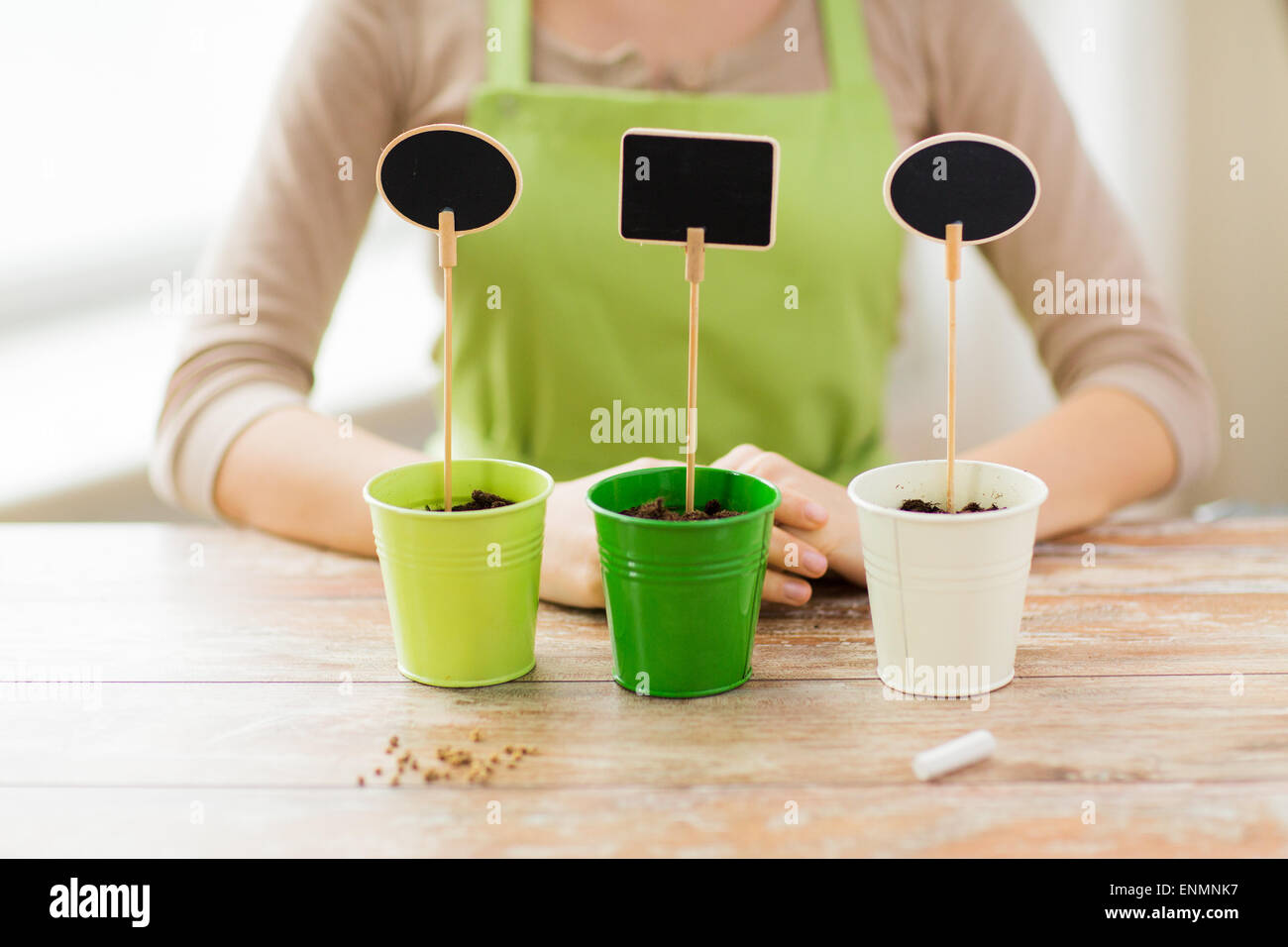 close up of woman over pots with soil and signs Stock Photo - Alamy