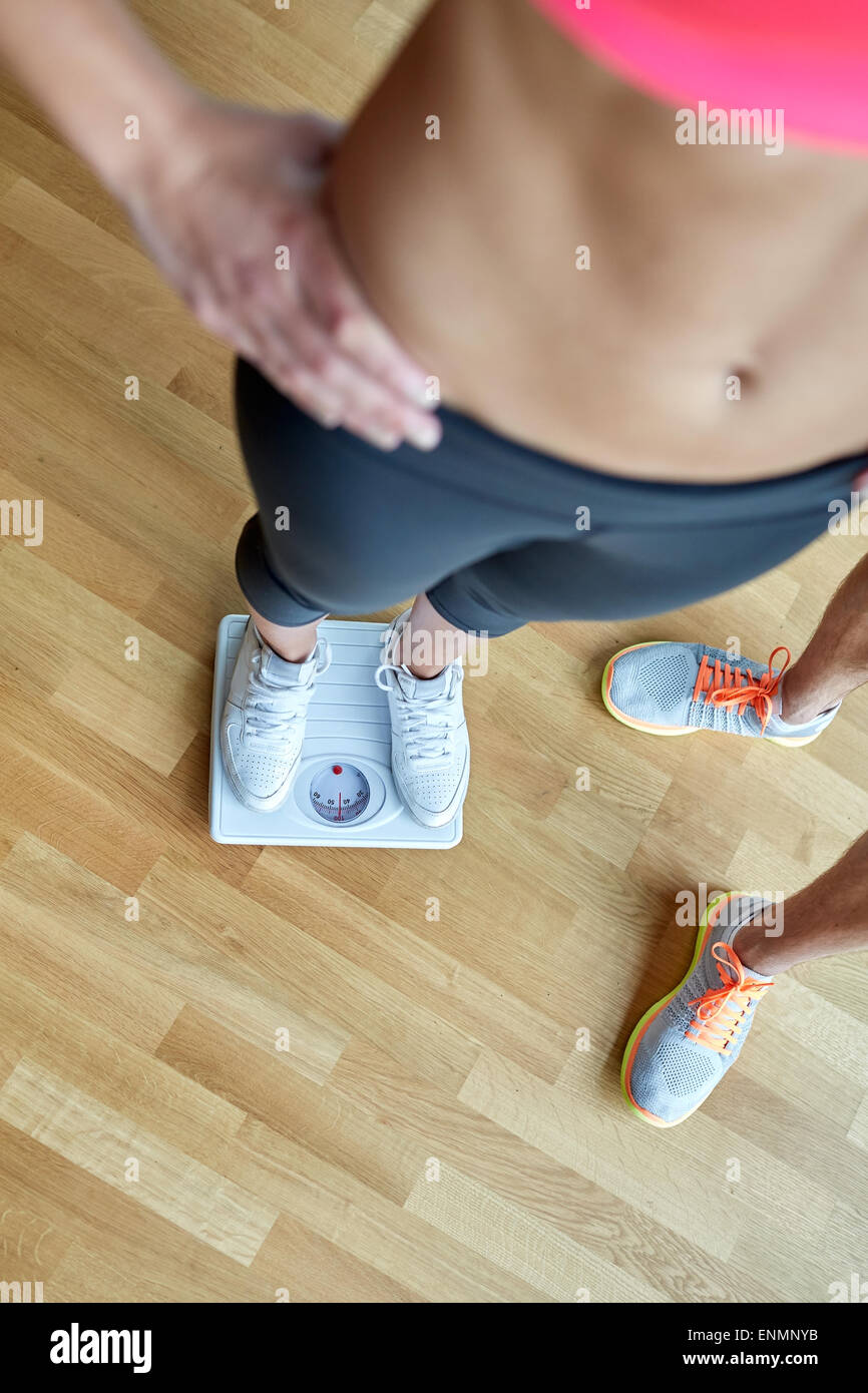 close up of man and woman with scales in gym Stock Photo Alamy