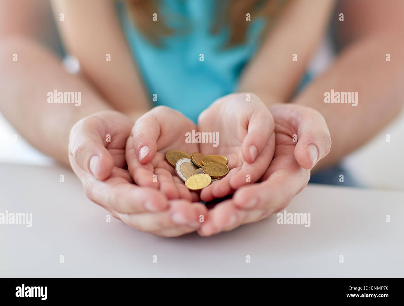 close up of family hands holding euro money coins Stock Photo