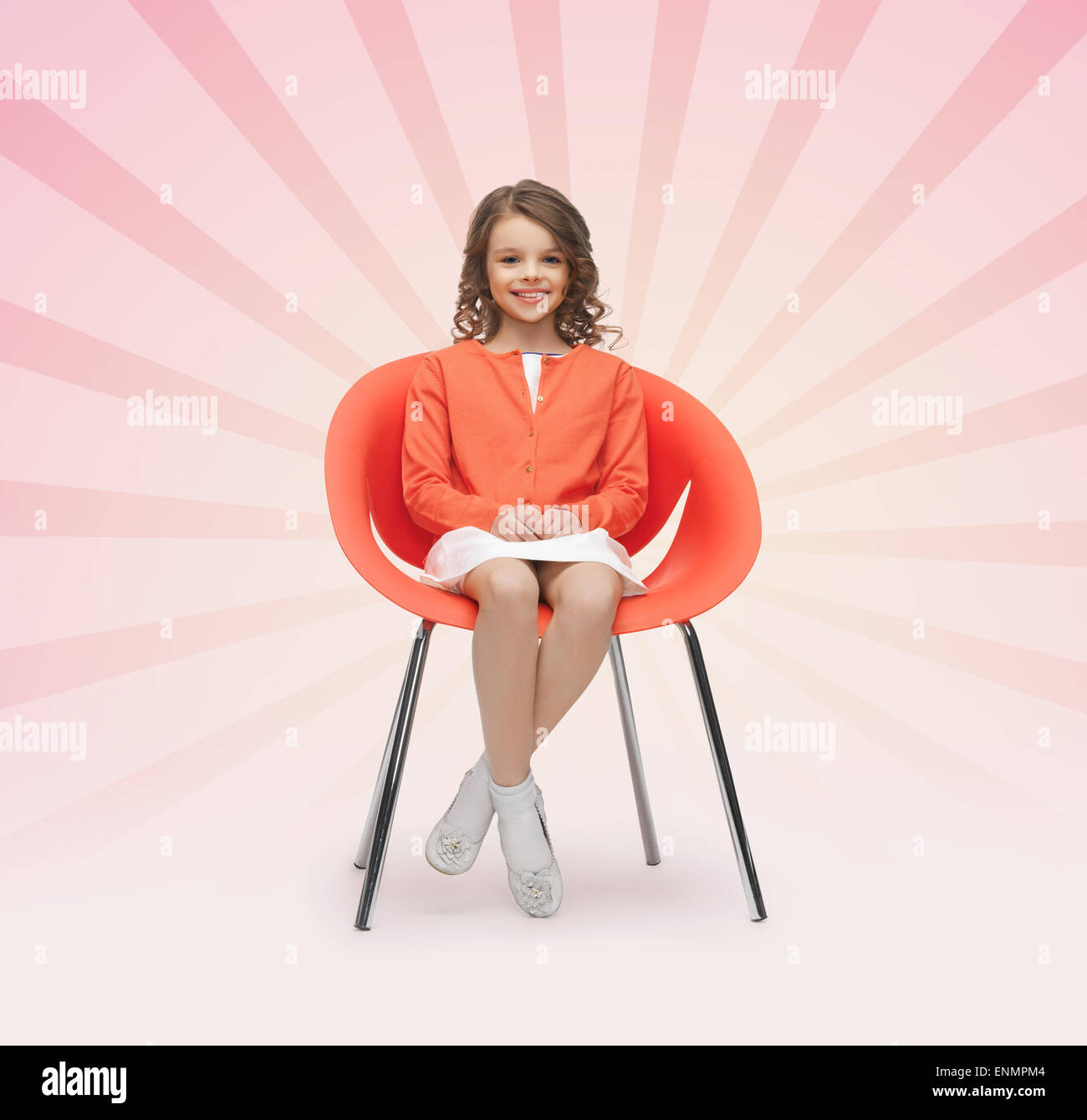 happy little girl sitting on designer chair Stock Photo - Alamy