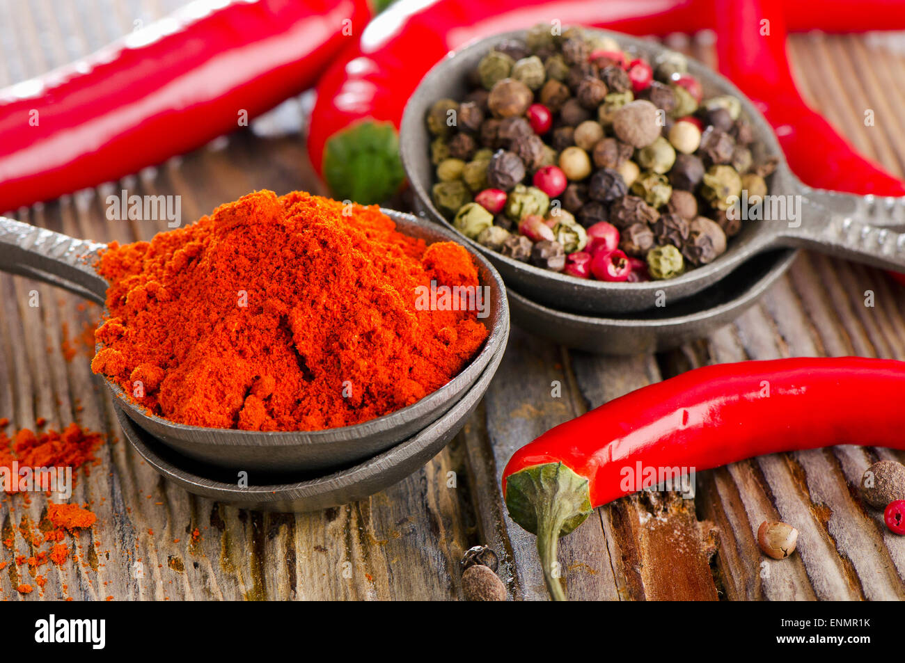 Black  and red  peppers on a wooden table. Selective focus Stock Photo