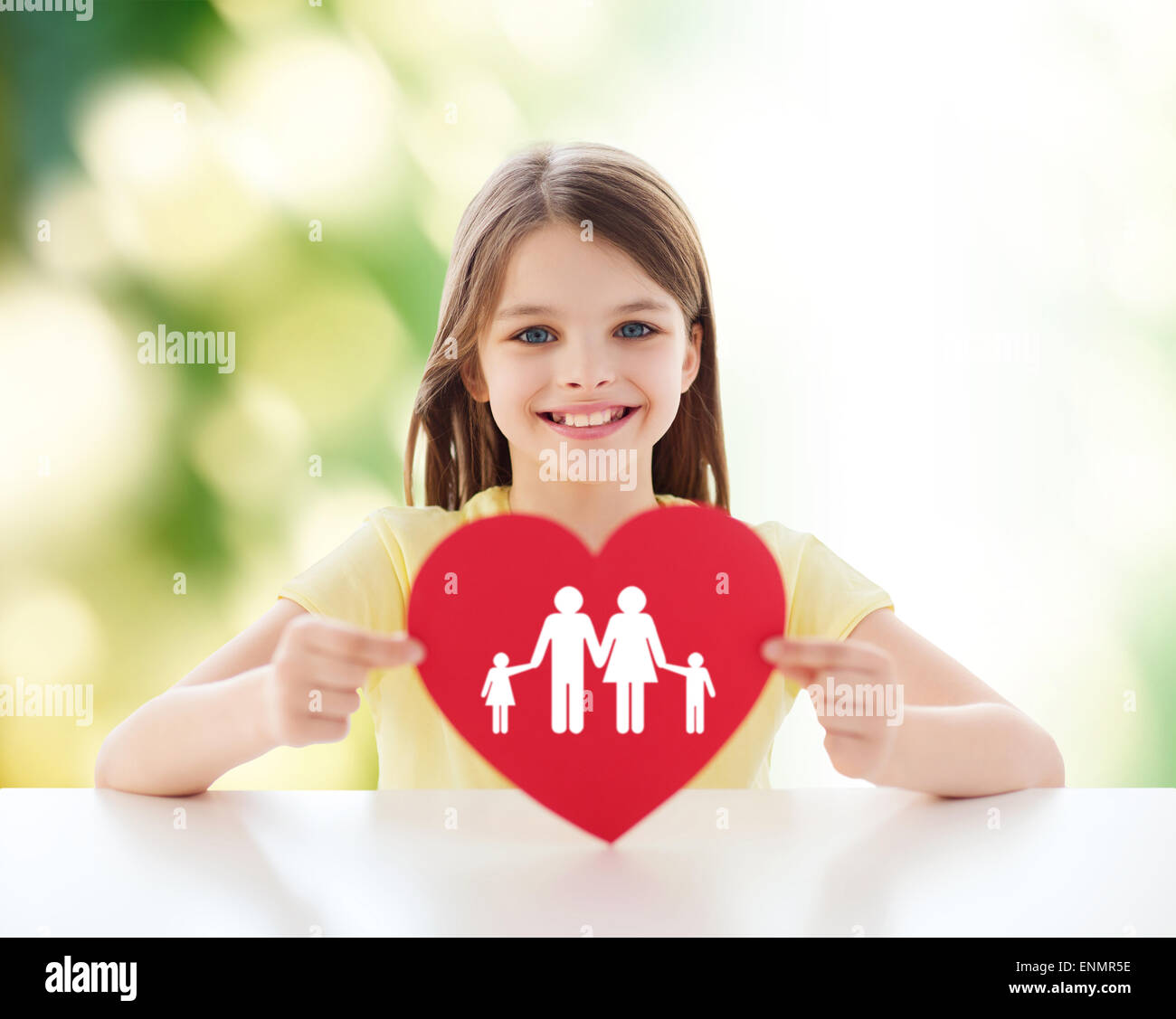 beautiful little girl sitting at table Stock Photo