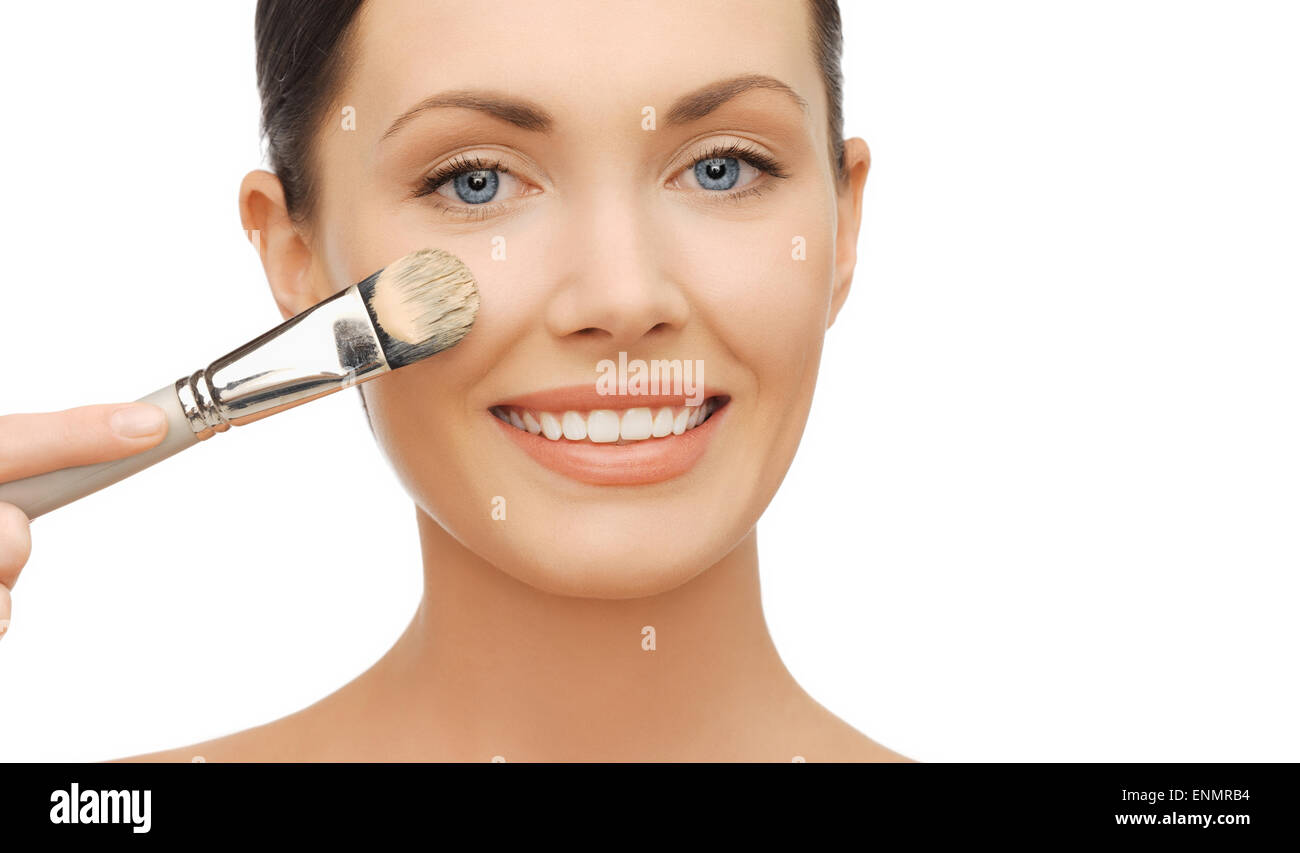 woman applying liquid foundation with brush Stock Photo Alamy
