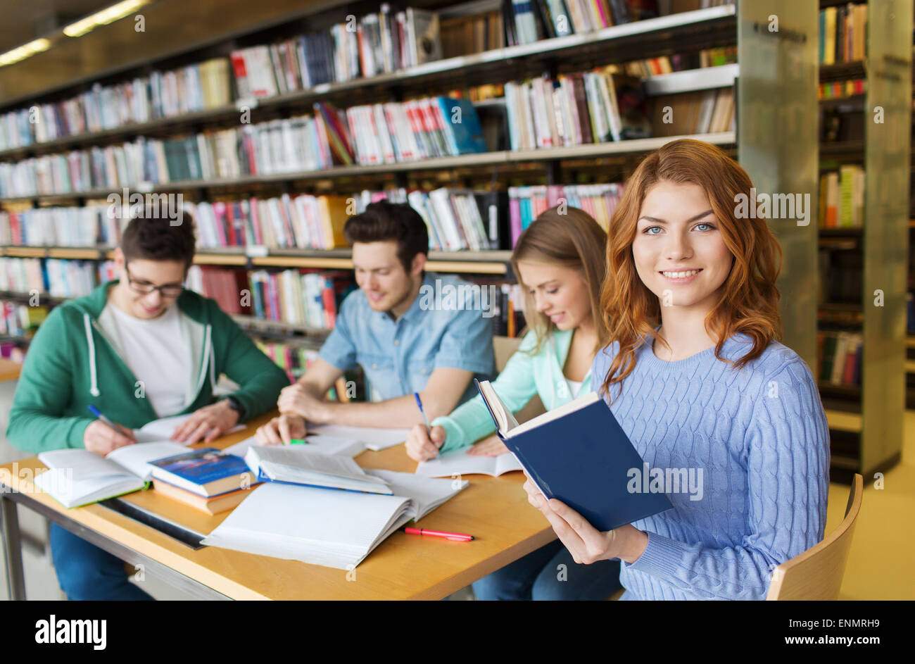 happy students reading books in library Stock Photo - Alamy