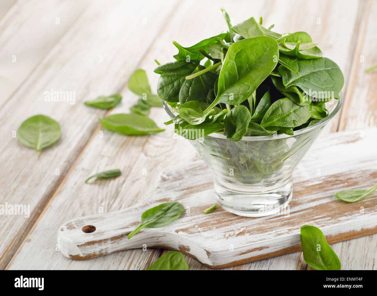 Green Spinach leaves in a glass bowl. Selective focus Stock Photo