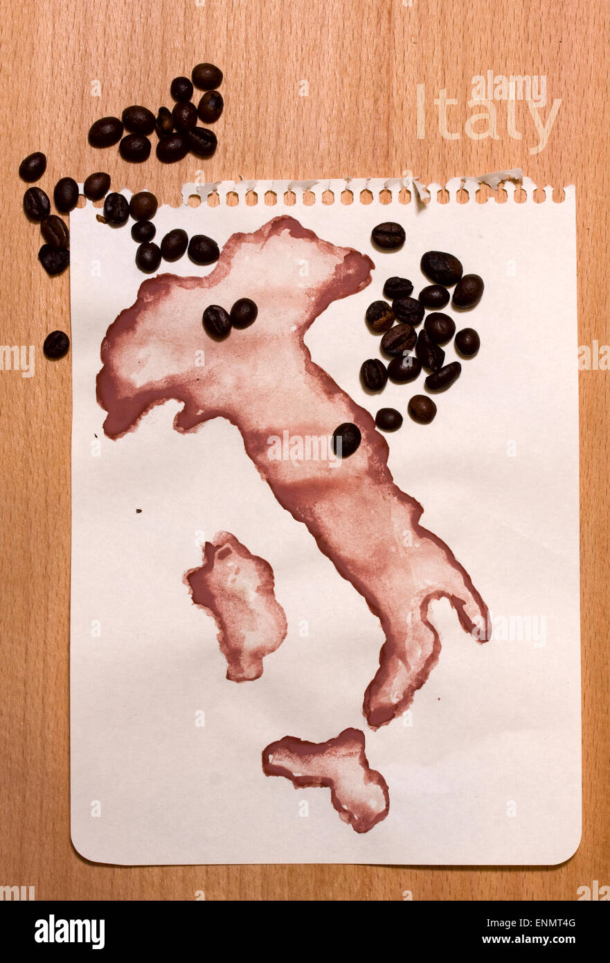 Roughly drawn on the sheet of paper with gouache map of Italyl and coffee beans on it Stock Photo