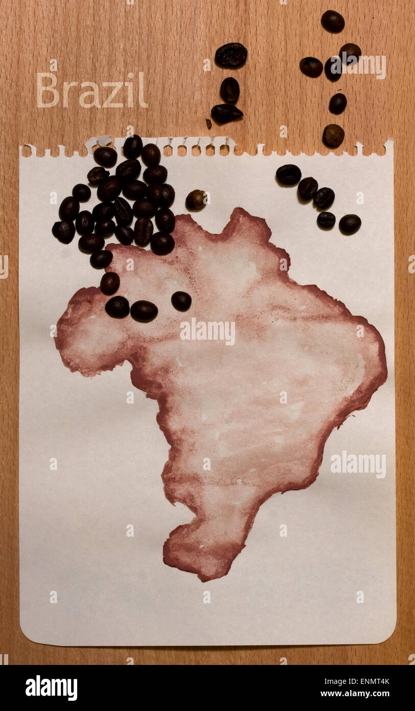 Roughly drawn on the sheet of paper with gouache map of Brazil and coffee beans on it Stock Photo