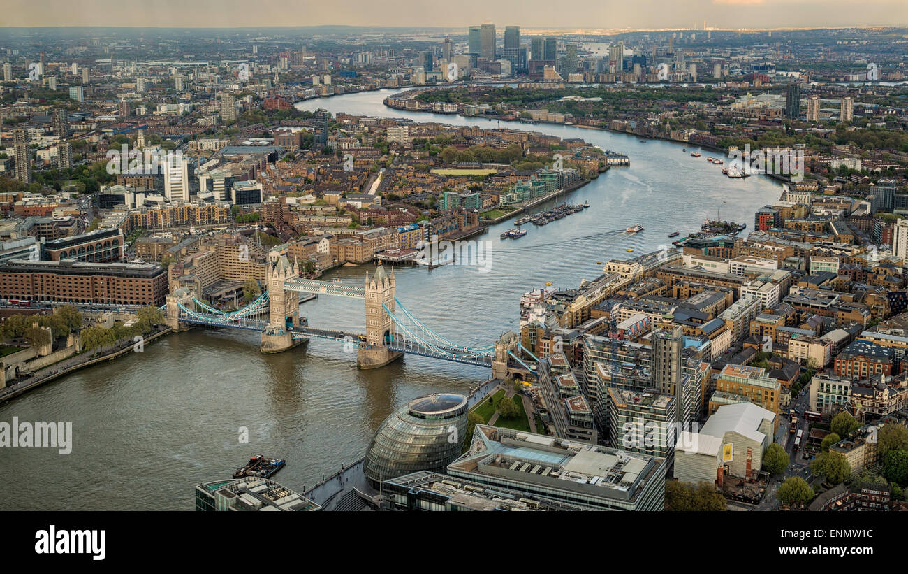 Overhead view of Tower Bridge and the skyline of London in England with the river Thames winding through the city Stock Photo