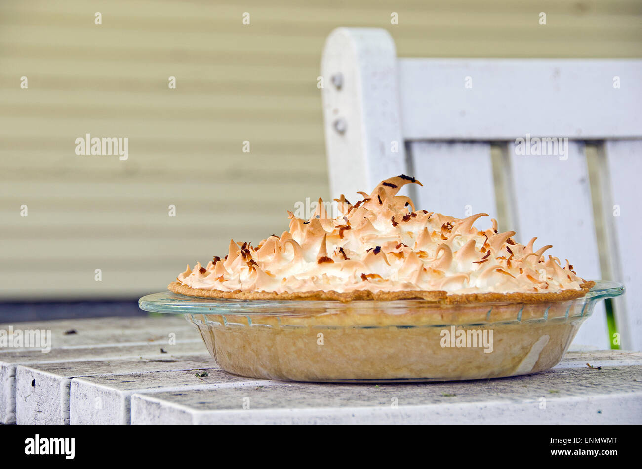 Homemade coconut cream pie on an outdoor table. Stock Photo