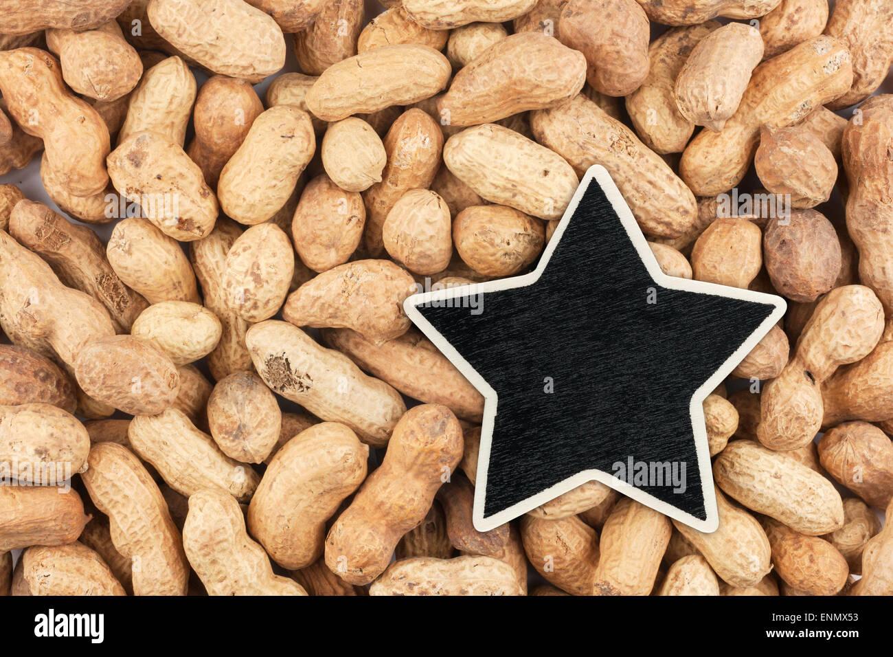 Star, pointer, price, tag, lies on peanuts, with space for your text Stock Photo
