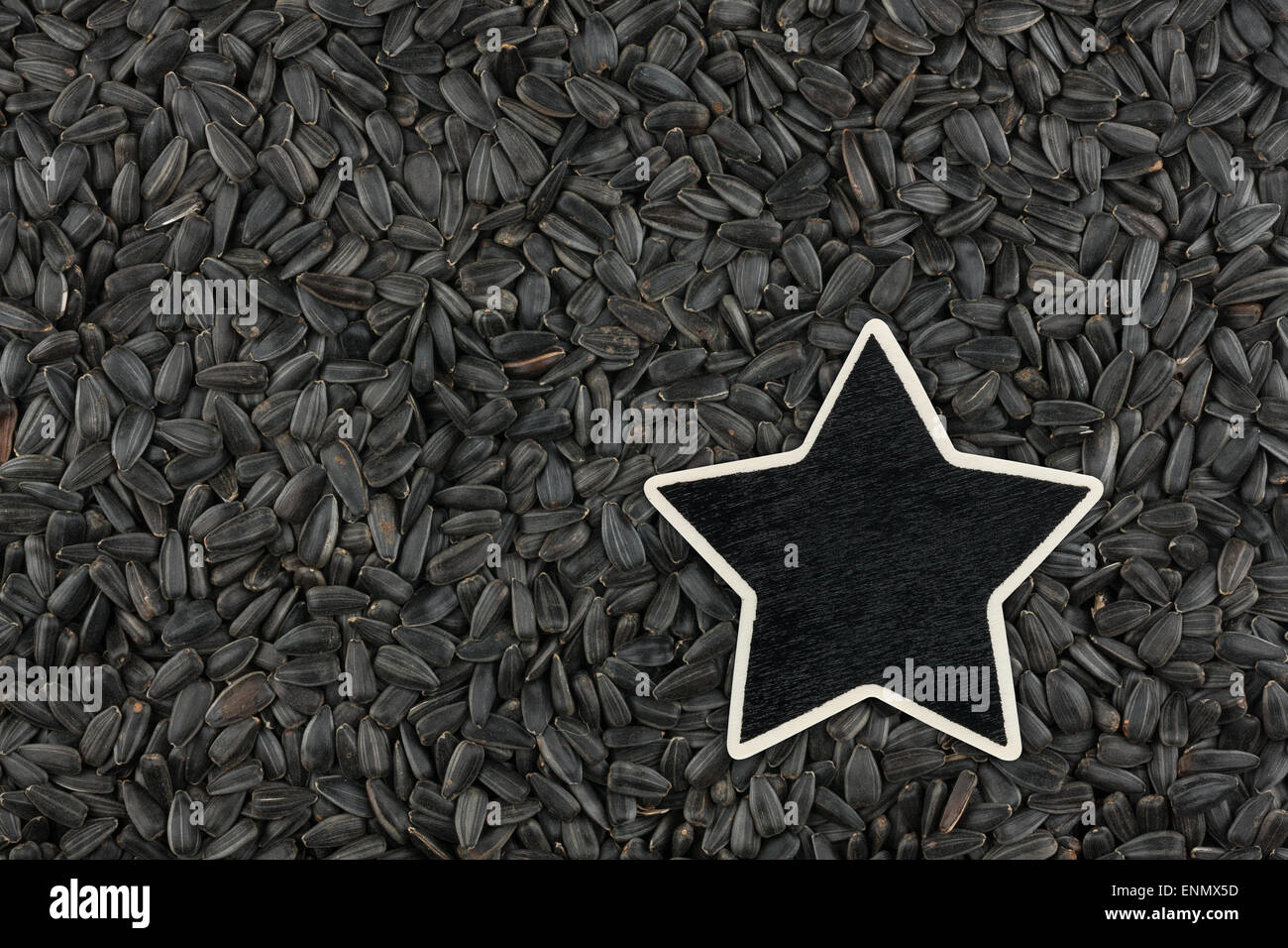 Star, pointer, price, tag, lies on sunflower  seeds,  with space for your text Stock Photo