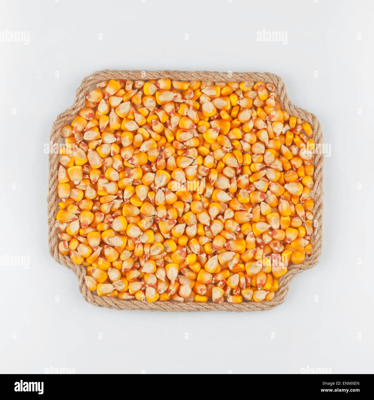 Frame made of rope with corn lying on a white background, with place ...