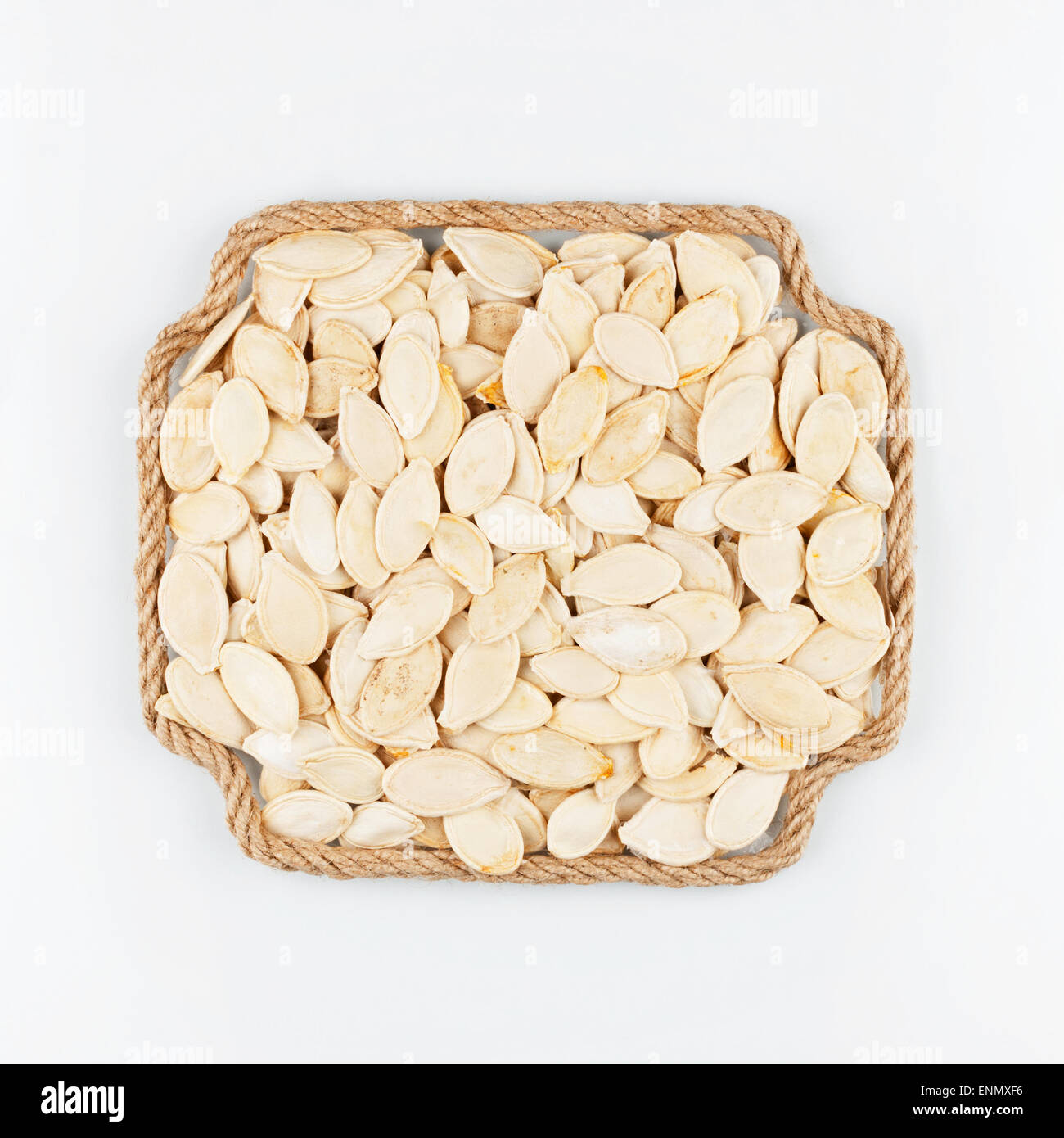 Frame made of rope with  pumpkin  seeds  lying on a white background, with place for your text, graphics Stock Photo