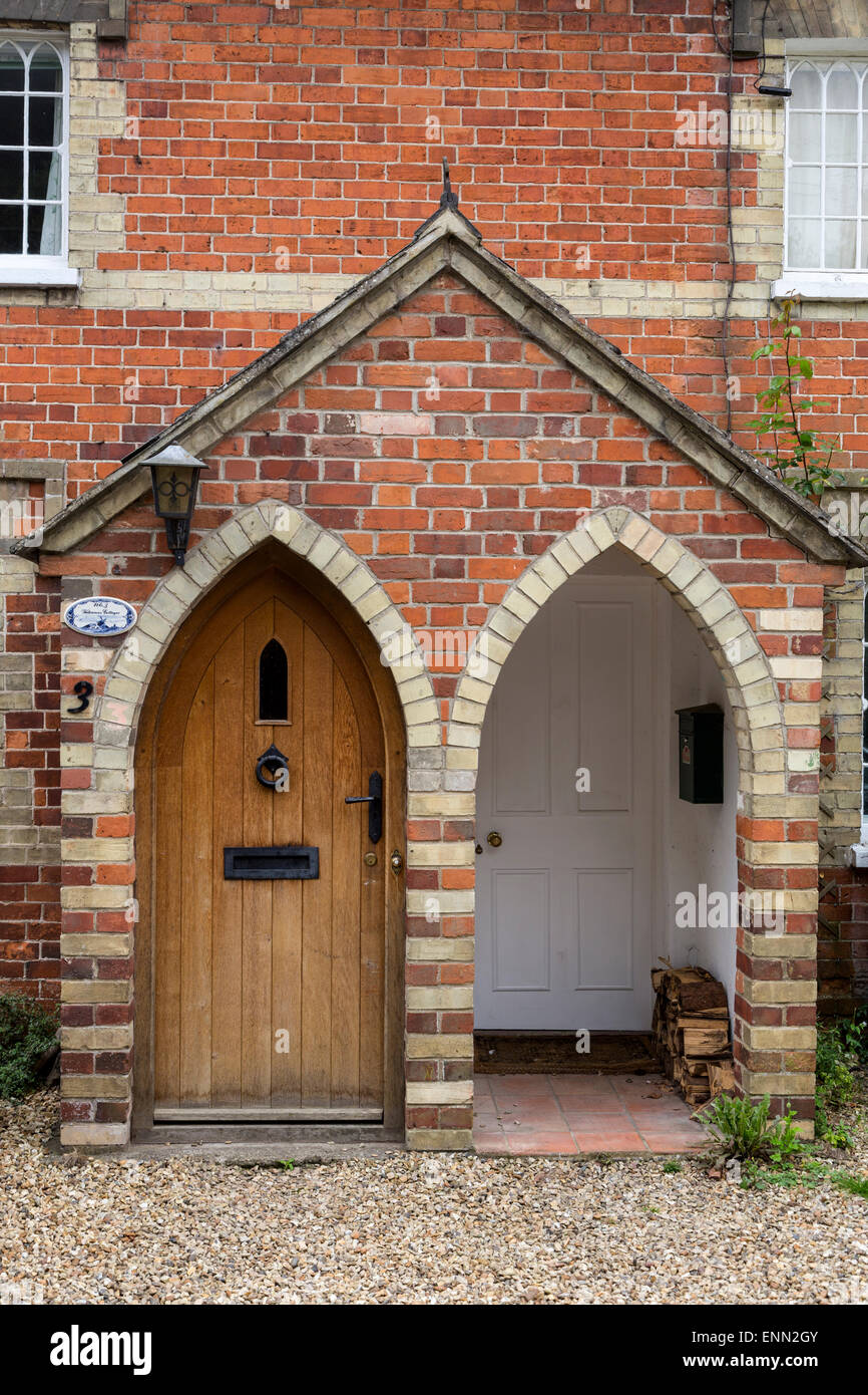 UK, England, Ewelme.  Arched Entryways to Two Duplexes, English Country Village. Stock Photo