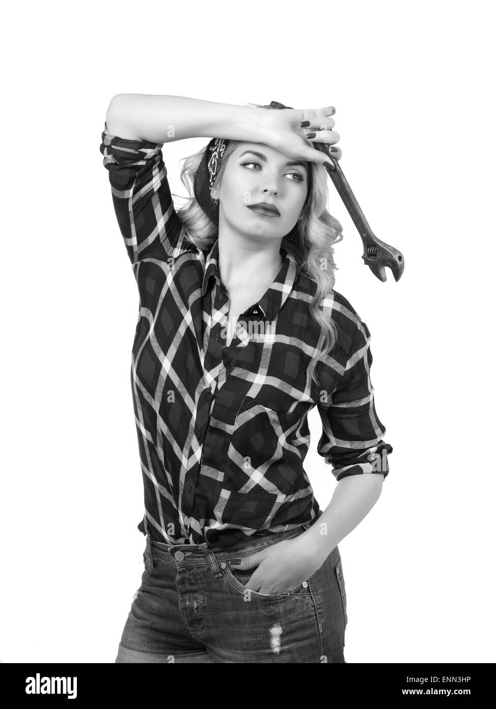 The blonde holds a wrench on a white background Stock Photo