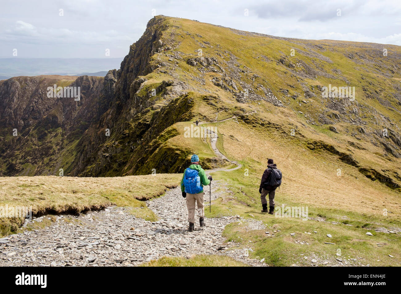 Hikers on Minffordd path from Penygadair to Craig Cau peak in Cadair Idris mountain range in Snowdonia Wales UK Stock Photo