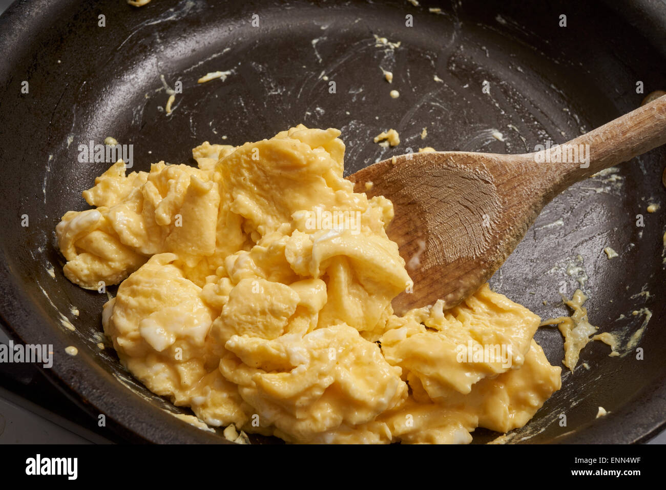 making scrambled eggs in an iron skillet Stock Photo Alamy