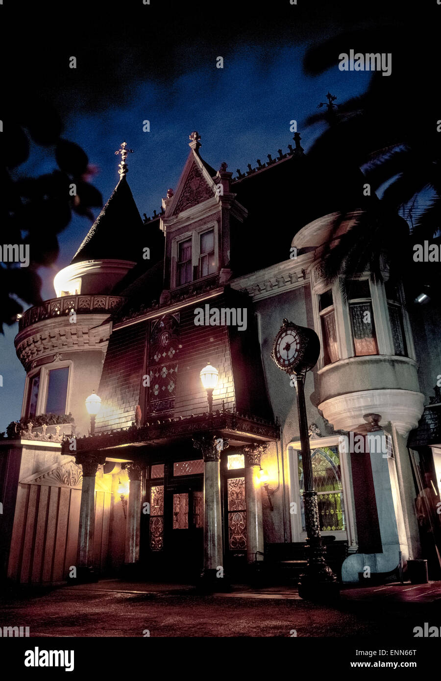 A nighttime view of the entrance to the world-famed Magic Castle, a private nightclub for magicians and magic enthusiasts in Hollywood, California, USA. Entry to the 1909 mansion is only for those who belong to the Academy of Magical Arts, an organization devoted to the advancement of the ancient art of magic. Academy members and their guests are treated nightly to a number of magic shows as well as dining and drinking at this historic social club. Stock Photo