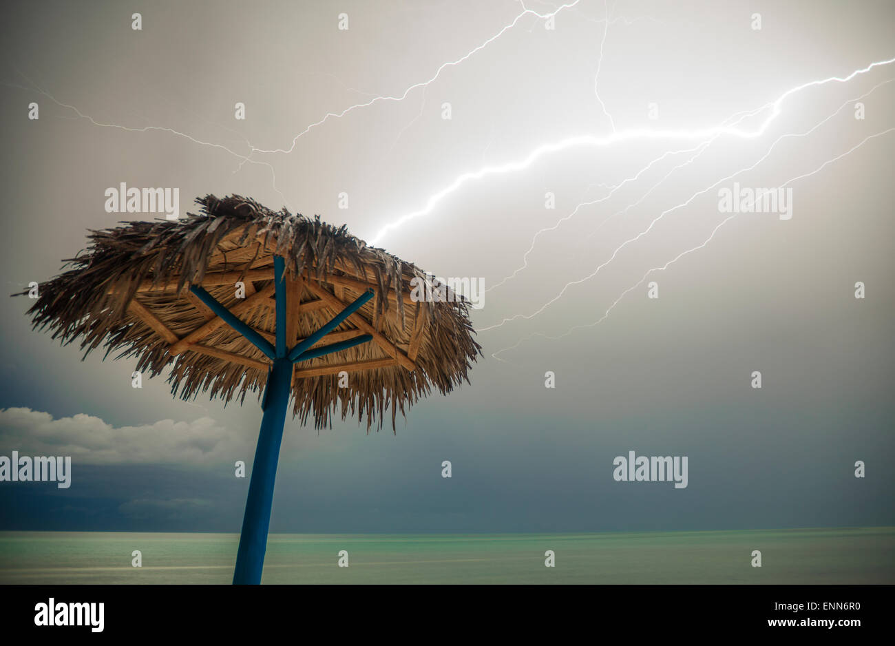 Lightning strikes a beach umbrella on Playa La Jaula beach, Cayo Coco, Cuba. Stock Photo