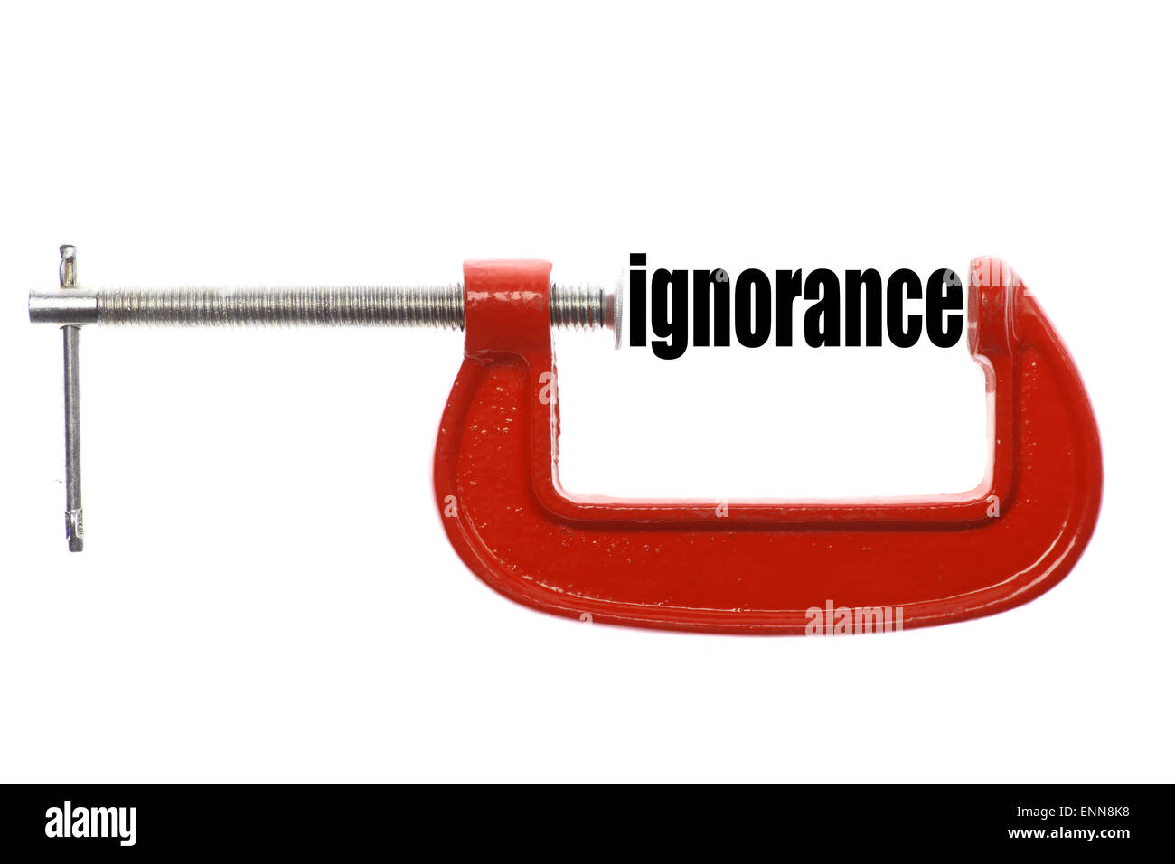 The word 'ignorance' is compressed with a vice. Stock Photo