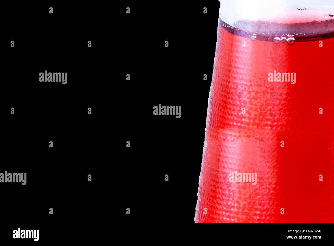 Red drink in the bootle. Black background Stock Photo