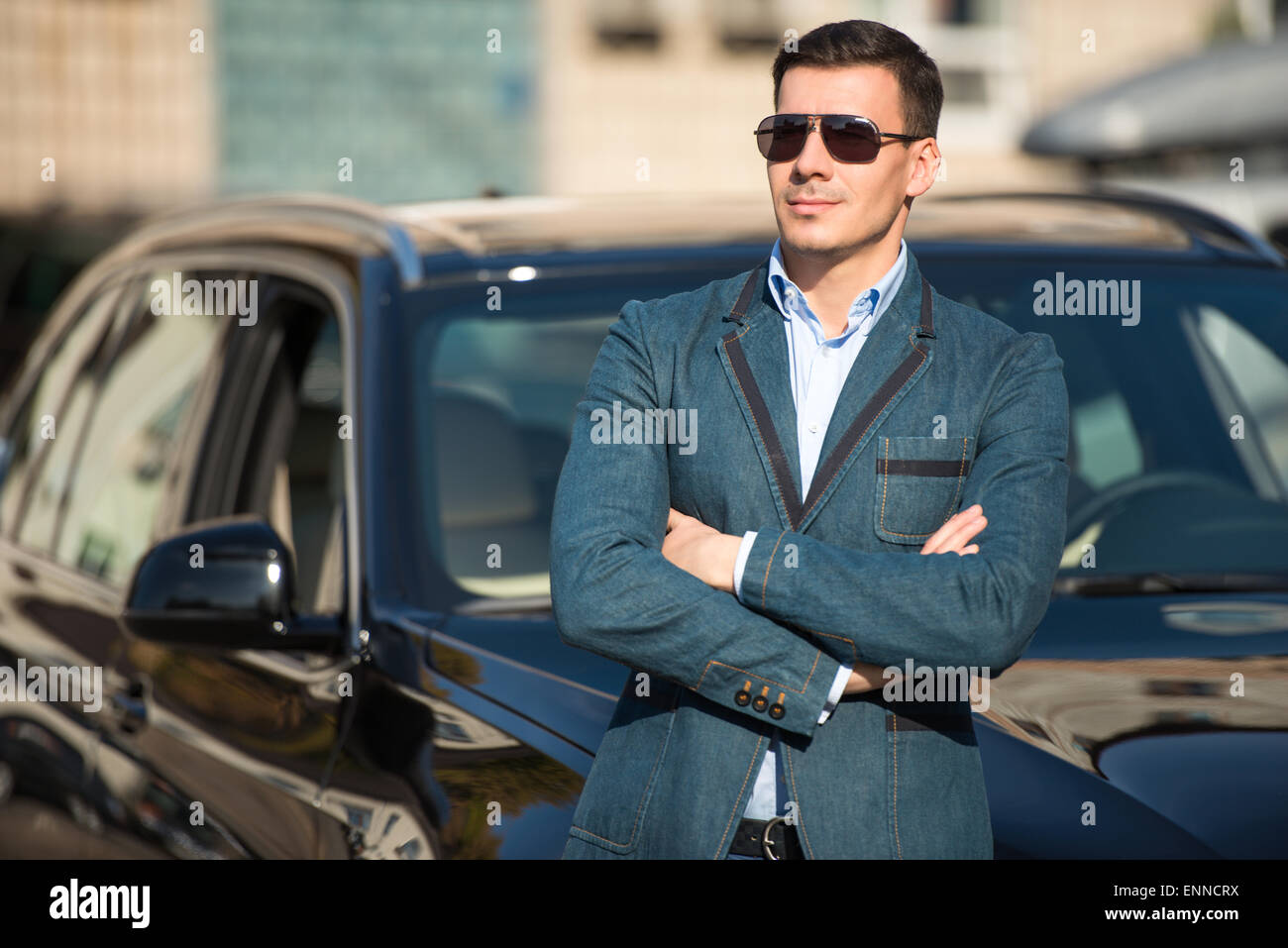Young man leaned on his car Stock Photo