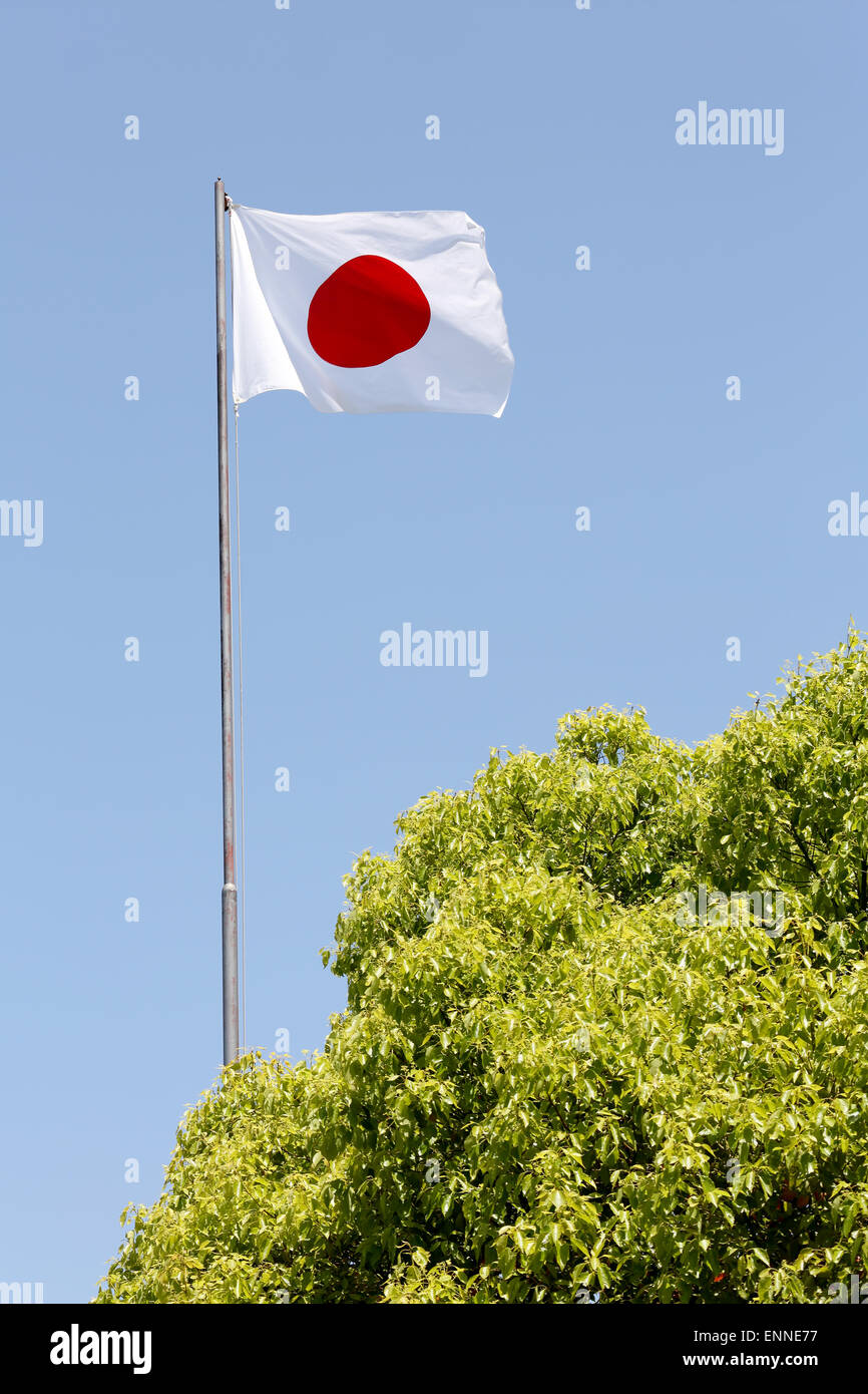 Japanese flag in wind against clear blue sky Stock Photo Alamy