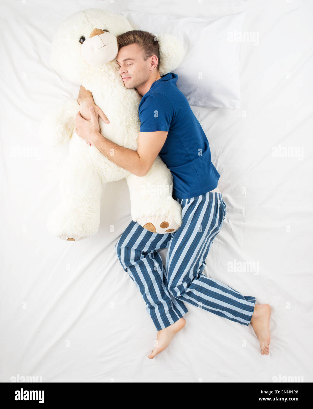 Man sleeping with large teddy bear Stock Photo Alamy