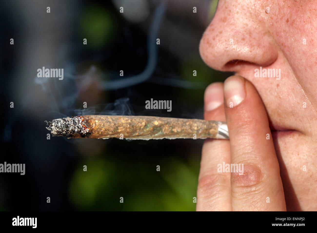 Close up, man smoking marijuana joint Stock Photo