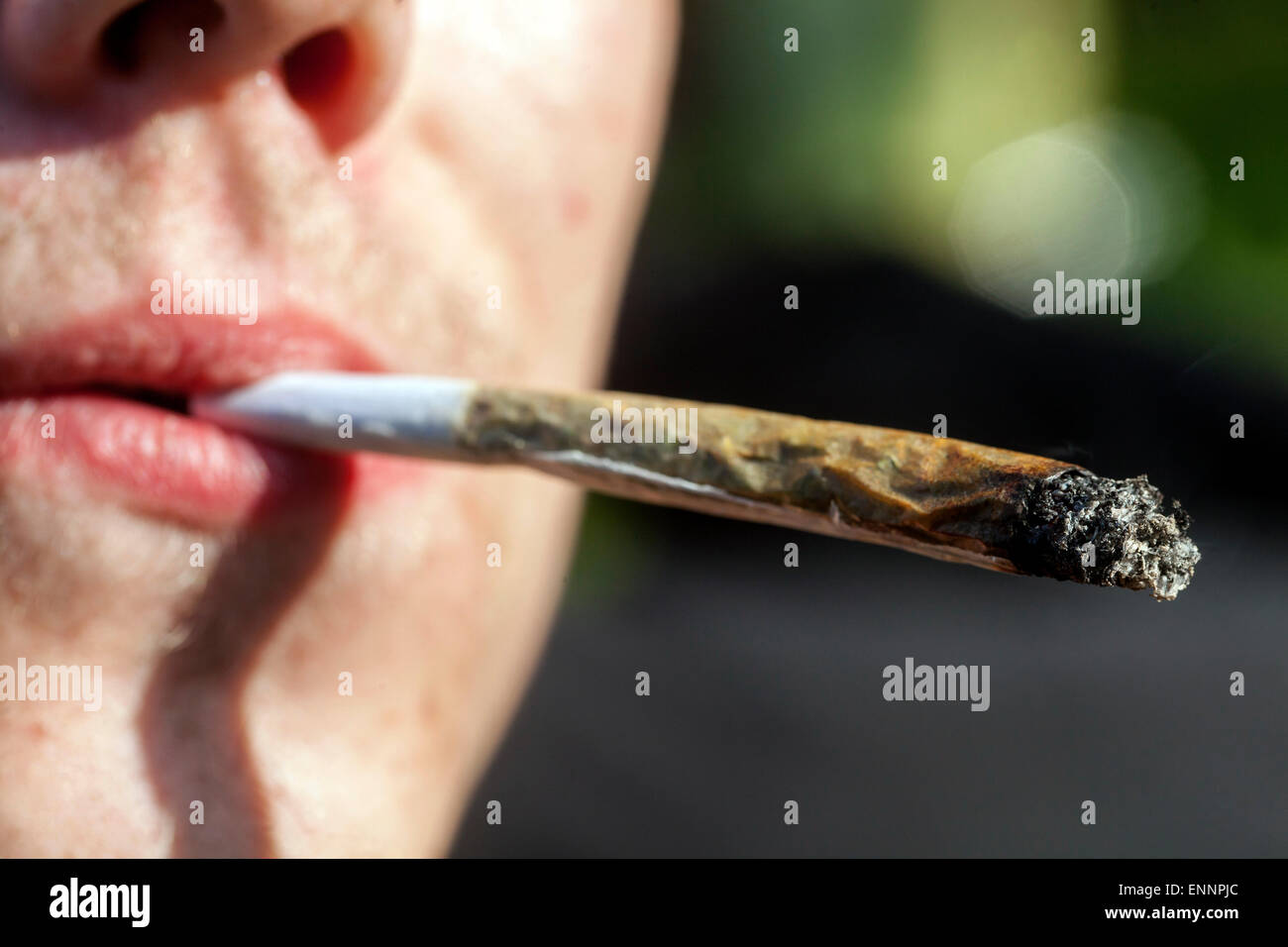 Close up, man smoking marijuana joint Stock Photo