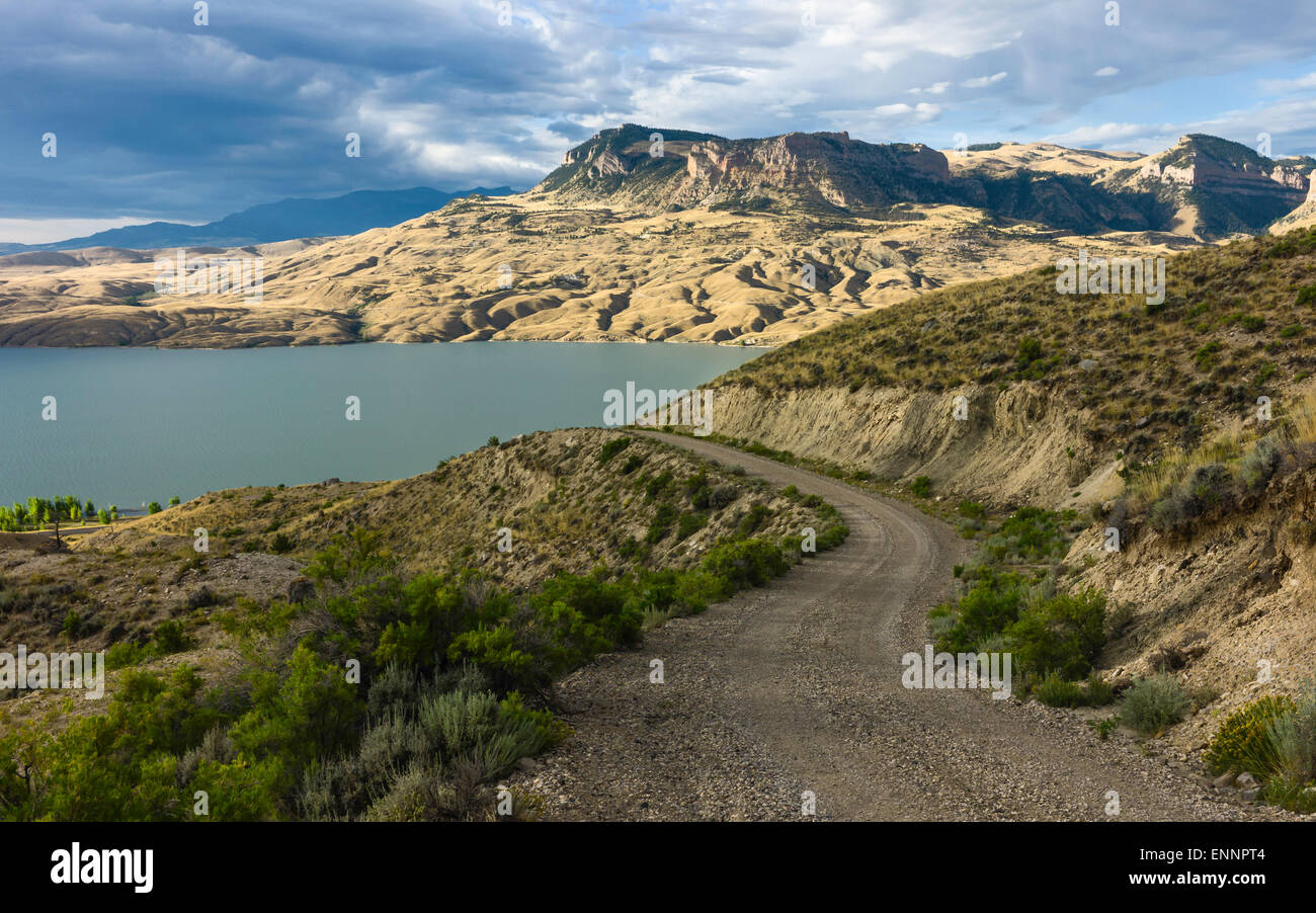 The arid landscape of Buffalo Bill State Park with the Shoshone River flanked by rolling landscape and mountains  at dawn. Stock Photo