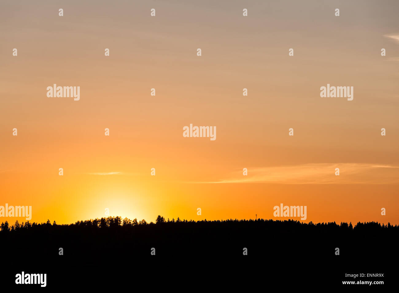 Sunset behind lake and forest Stock Photo