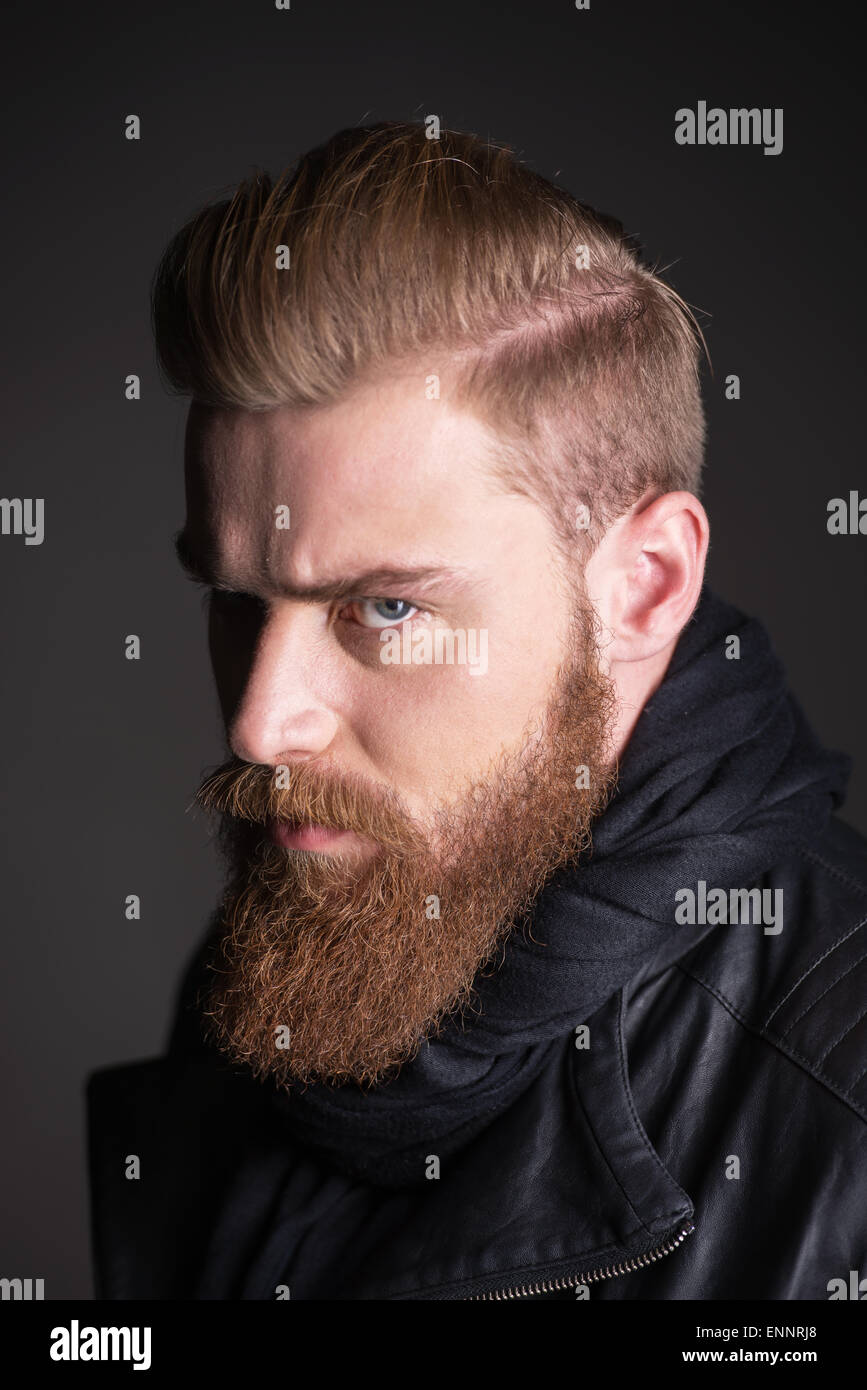 Young man with beard looking at camera Stock Photo - Alamy