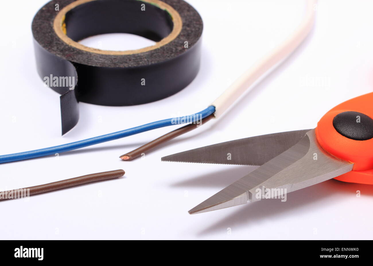 Cable cutter, electric wire and black insulating tape on white