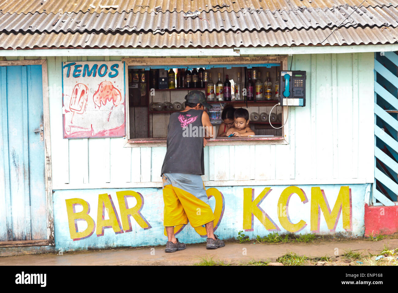 An outdoor bar in Maues, Brazil with the youngest bar tender Stock Photo