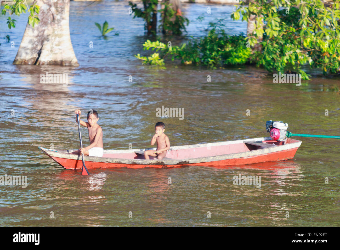Young native children on the Amazon river during the wet season. 2 boys. Stock Photo