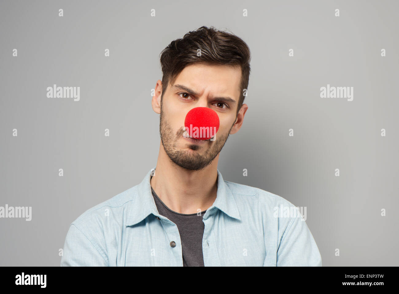 Sad young man with clown nose Stock Photo