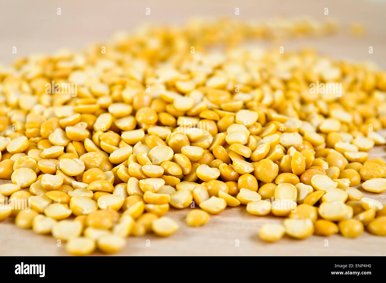 Yellow split peas on chopping board Stock Photo