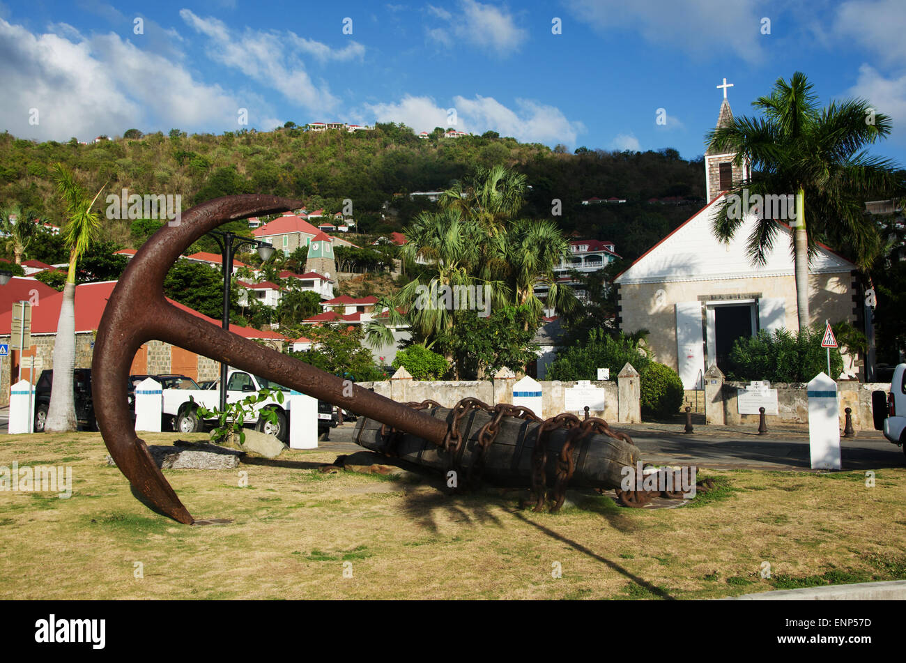 Saint-Barthélemy, French West Indies, Caribbean: a sculpture in the form of an anchor, the skyline of Gustavia and the Anglican Church Stock Photo