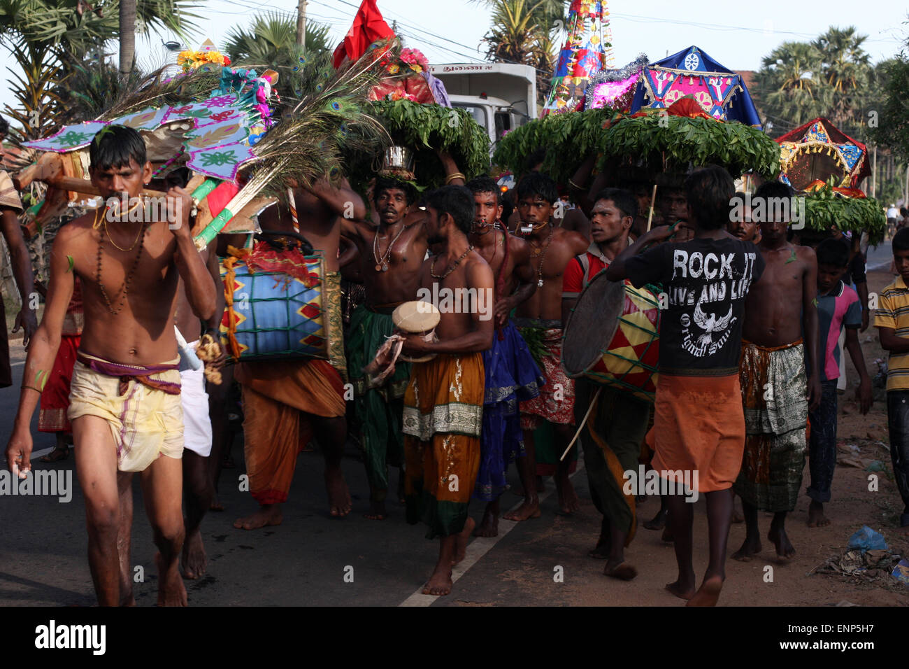 Musicians and man with piercing to enact his religious devotion, in Tamil Hindu procession near Trincomalee, Sri Lanka Stock Photo