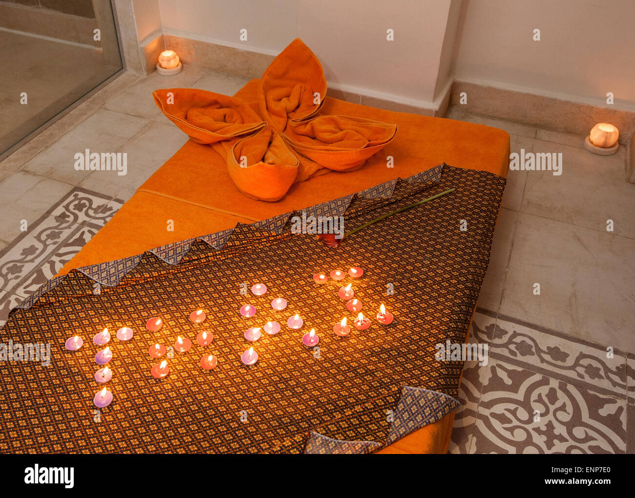 Closeup detail of a Thai massage bed on the floor in luxury health spa with candles Stock Photo
