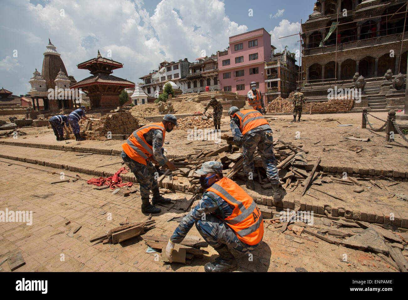 Police clear the rubble in Patan's (Lalitpur's) Durbar Square, which was badly damaged following the 2015 earthquake in Nepal. Stock Photo