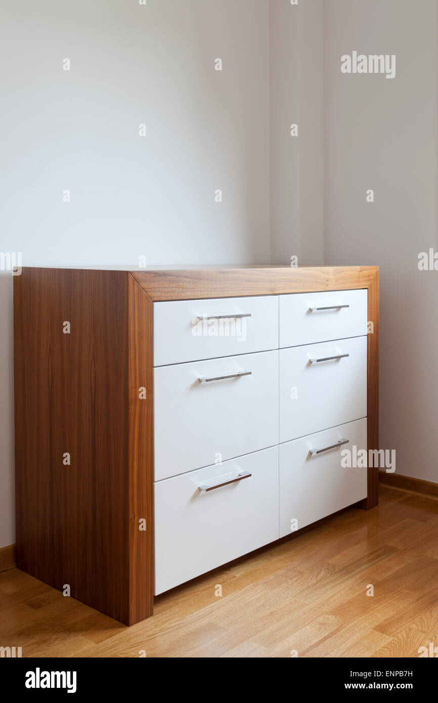 wooden chest of drawers in the room Stock Photo