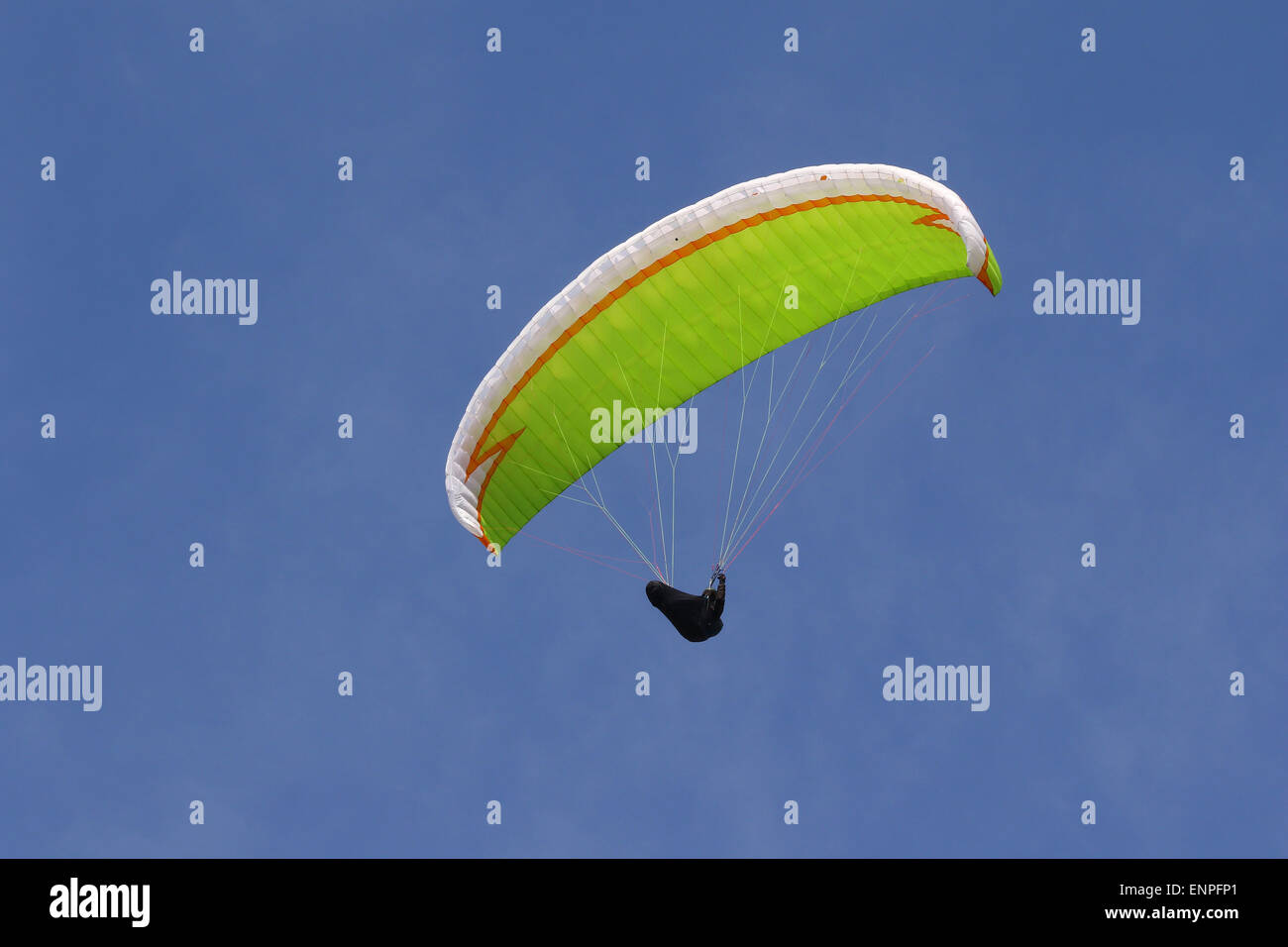 Lime color parachute high in the sky Stock Photo