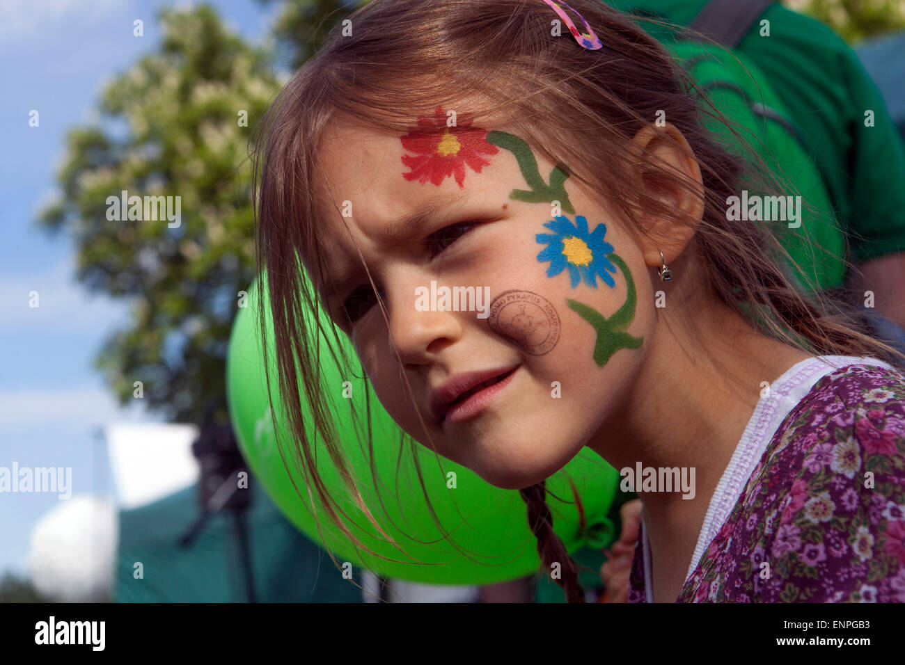 Girl with painted flowers on her face child face painting Stock Photo