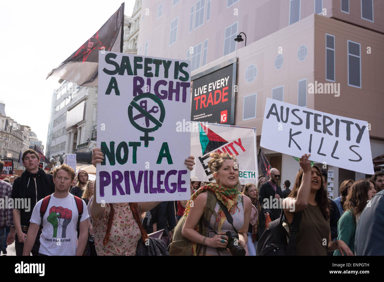 London, 9th May 2015. Protesters hold up placards which read 'Safety is a right, not a privilege' and 'Austerity kills' as a demonstration marches in central London in protest at the 7th May 2015 general election result, which saw the conservatives win a majority. Credit:  Patricia Phillips/Alamy Live News Stock Photo