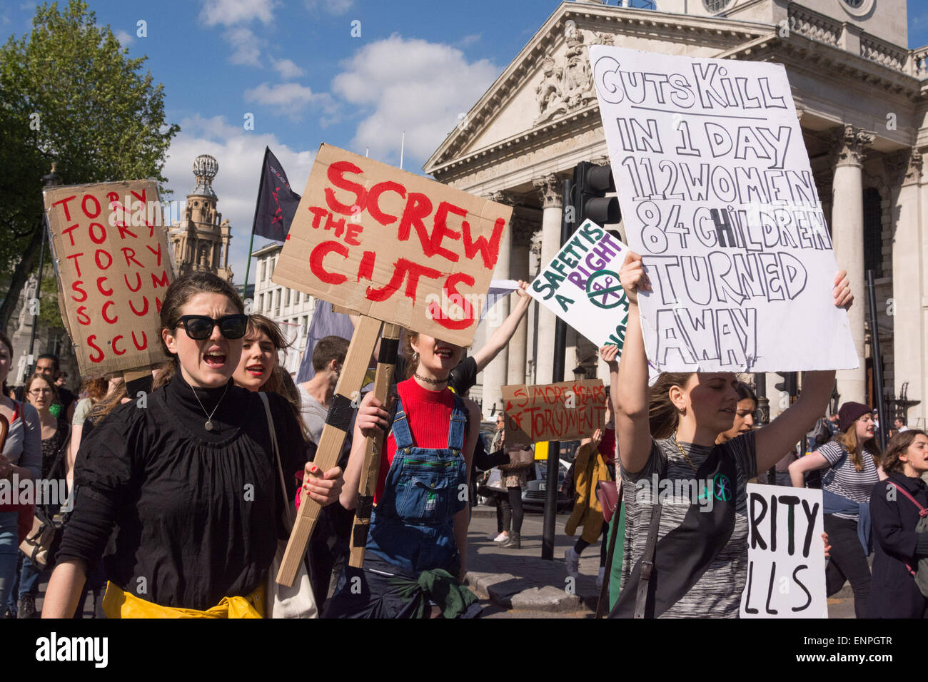 London, 9th May 2015. Women hold up placards which read 'Tory tory tory scum scum scum,' 'Screw the cuts' and 'cuts kill in 1 day 112 women 84 children turned away' during a demonstration march in central London in protest at the 7th May 2015 general election result, which saw the conservatives win a majority.  Credit:  Patricia Phillips/Alamy Live News Stock Photo